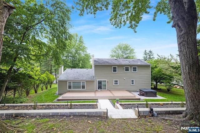 15 Kings Ct, Woodcliff Lake, NJ 07677 - rear view of property with a patio, a lawn, a chimney, a hot tub, and a wooden deck