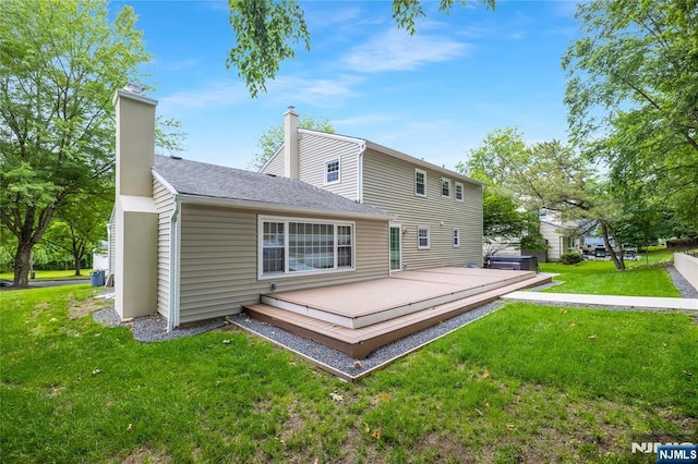 15 Kings Ct, Woodcliff Lake, NJ 07677 - back of property featuring a lawn, a chimney, a deck, and roof with shingles