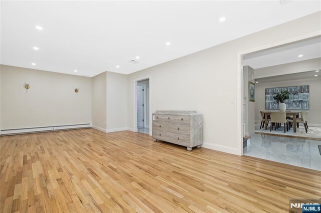 15 Kings Ct, Woodcliff Lake, NJ 07677 - unfurnished room with baseboard heating, light wood finished floors, and recessed lighting