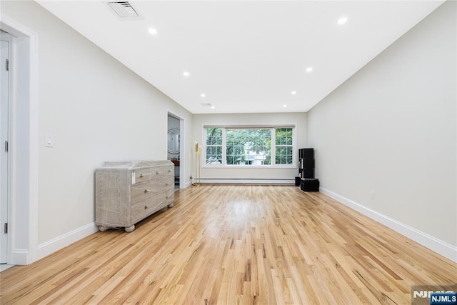 15 Kings Ct, Woodcliff Lake, NJ 07677 - unfurnished living room featuring a baseboard heating unit, wood finished floors, and recessed lighting