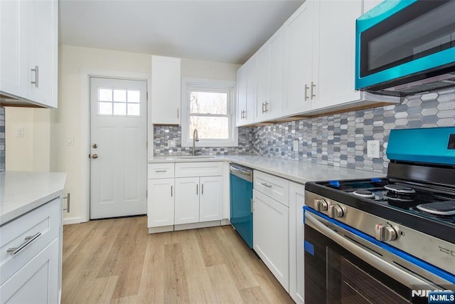 419 Central Ave, Haledon, NJ 07508 - kitchen featuring stainless steel range with electric cooktop, dishwasher, light countertops, light wood-style flooring, and white cabinetry