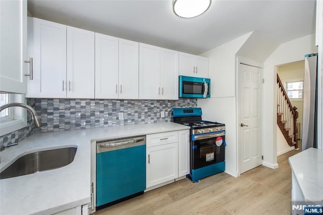 419 Central Ave, Haledon, NJ 07508 - kitchen with stainless steel appliances, light wood-style flooring, white cabinets, tasteful backsplash, and light stone countertops