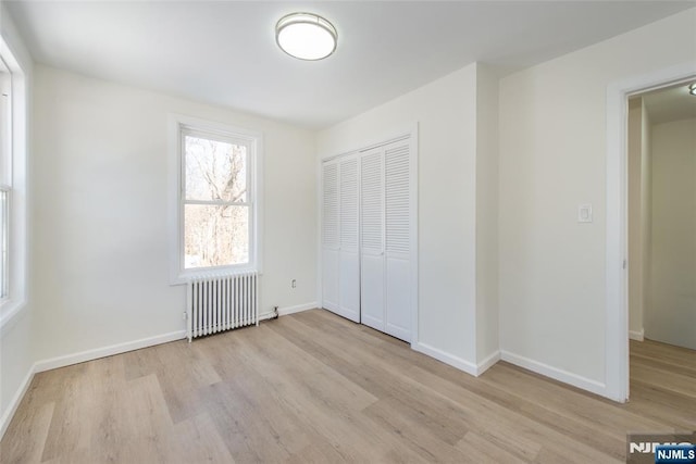 419 Central Ave, Haledon, NJ 07508 - unfurnished bedroom with radiator heating unit, wood finished floors, and a closet