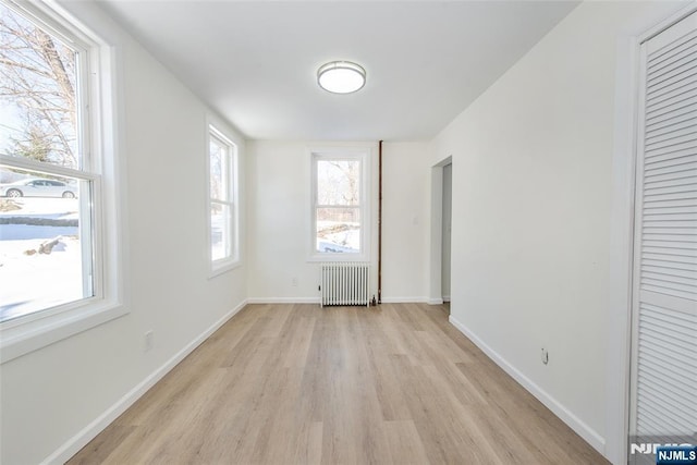 419 Central Ave, Haledon, NJ 07508 - unfurnished room featuring radiator heating unit and light wood finished floors