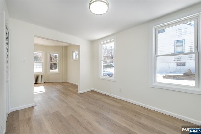 419 Central Ave, Haledon, NJ 07508 - unfurnished room with radiator heating unit and light wood-type flooring