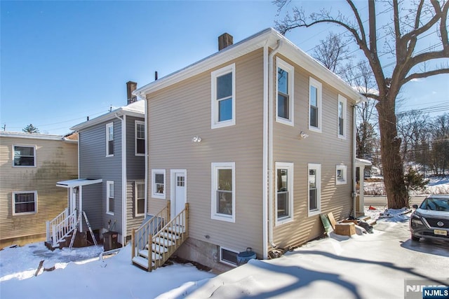 419 Central Ave, Haledon, NJ 07508 - snow covered property with entry steps and a chimney