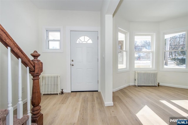 419 Central Ave, Haledon, NJ 07508 - foyer entrance featuring radiator, light wood-style flooring, and stairway