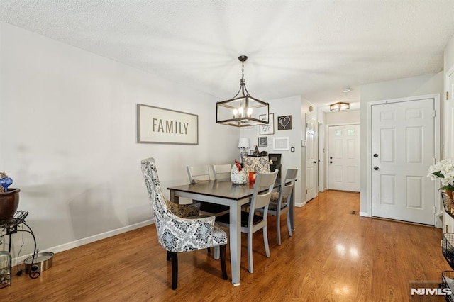 16 Iron Forge Vlg, Pompton Lakes, NJ 07442 - dining space featuring a chandelier and wood finished floors