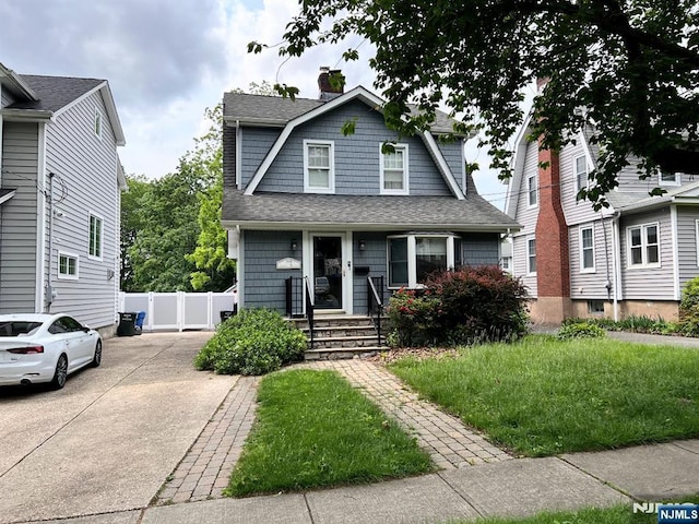 360 Carmita Ave, Rutherford, NJ 07070 - dutch colonial with a gambrel roof, roof with shingles, a chimney, and driveway
