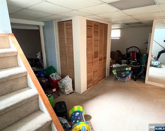 360 Carmita Ave, Rutherford, NJ 07070 - below grade area with stairs, a drop ceiling, and carpet floors