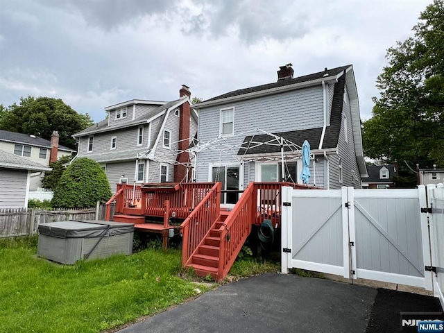 360 Carmita Ave, Rutherford, NJ 07070 - back of property with a gate, a deck, and a chimney