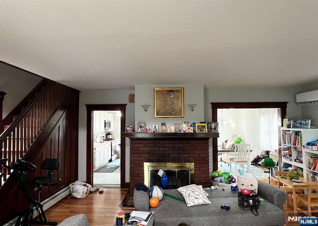 360 Carmita Ave, Rutherford, NJ 07070 - living room featuring stairs, baseboard heating, wood finished floors, a fireplace, and an AC wall unit
