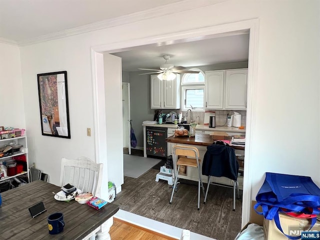 360 Carmita Ave, Rutherford, NJ 07070 - kitchen featuring wood finished floors, white cabinets, ornamental molding, light countertops, and a ceiling fan