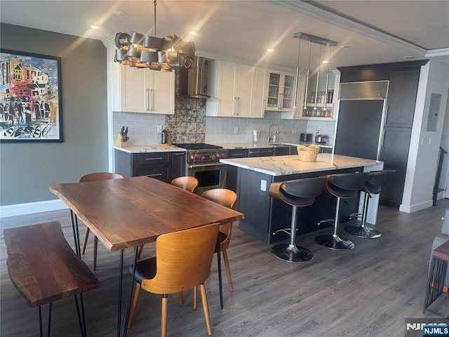 4 Horizon Rd Unit 1006, Fort Lee, NJ 07024 - kitchen featuring high end stove, wall chimney range hood, dark wood-style flooring, tasteful backsplash, and glass insert cabinets