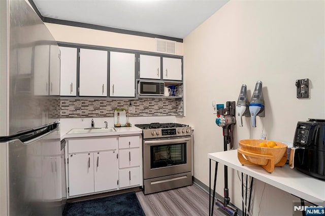 2000 Linwood Ave Unit 3P, Fort Lee, NJ 07024 - kitchen featuring gas range, freestanding refrigerator, black microwave, light wood-type flooring, and light countertops