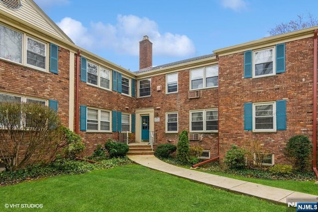 24 Hutton Ave Unit 46, West Orange, NJ 07052 - view of property featuring a chimney, a front lawn, and brick siding