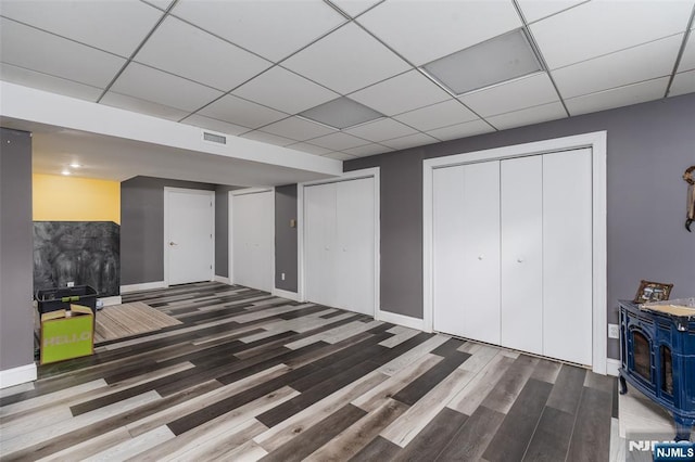 15 Franeks Rd, Hamburg, NJ 07419 - finished basement with wood finished floors, a paneled ceiling, and a wood stove