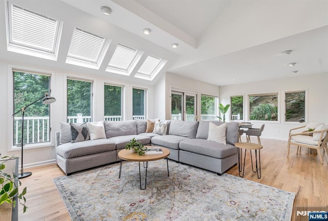 33 Berkshire Rd, Woodcliff Lake, NJ 07677 - living room with plenty of natural light, lofted ceiling, wood finished floors, recessed lighting, and a skylight