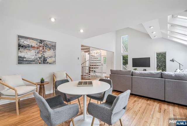 33 Berkshire Rd, Woodcliff Lake, NJ 07677 - dining space featuring light wood-style floors, vaulted ceiling, a chandelier, stairs, and recessed lighting