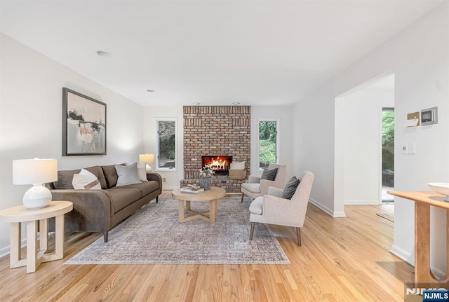 33 Berkshire Rd, Woodcliff Lake, NJ 07677 - living room with light wood-style flooring and a brick fireplace