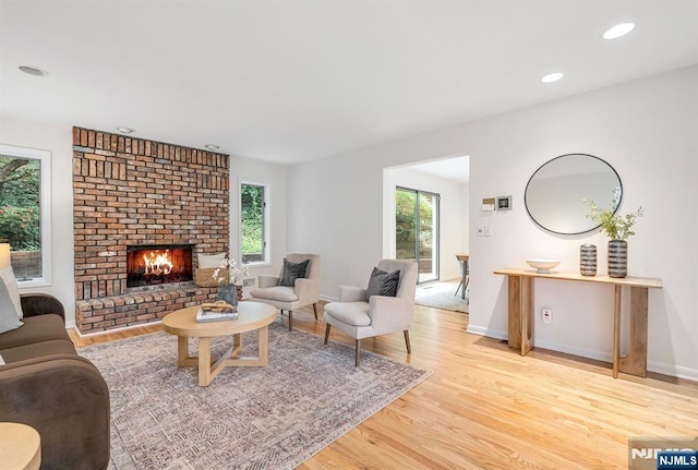 33 Berkshire Rd, Woodcliff Lake, NJ 07677 - living area featuring light wood finished floors, a brick fireplace, and recessed lighting