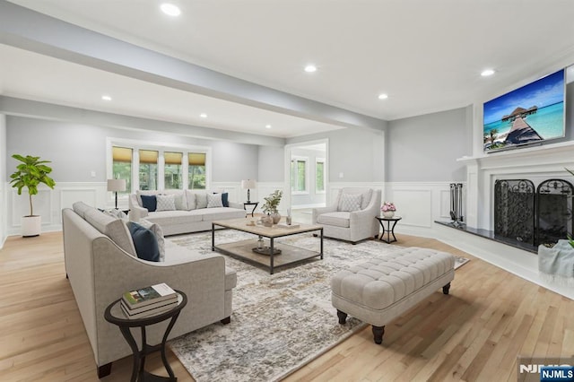 432 Fox Chase Rd, Chester Township, NJ 07930 - living room with a decorative wall, a wainscoted wall, light wood finished floors, and a fireplace with raised hearth