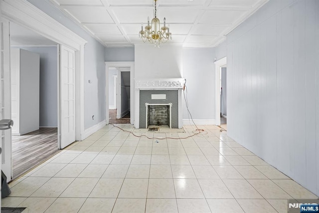 683 E 28th St, Paterson, NJ 07504 - unfurnished living room with a chandelier, a fireplace, light tile patterned floors, and ornamental molding