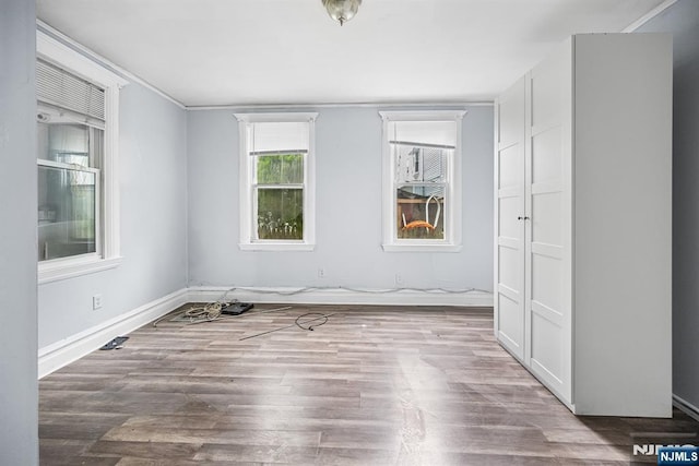 683 E 28th St, Paterson, NJ 07504 - unfurnished bedroom featuring wood finished floors and baseboards