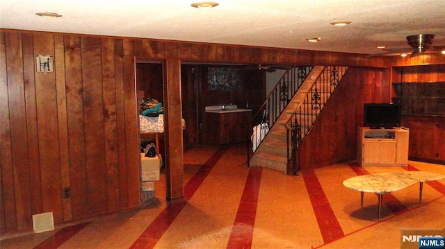 17 Gunther Ave, Lodi, NJ 07644 - interior space featuring a ceiling fan, wooden walls, and stairs