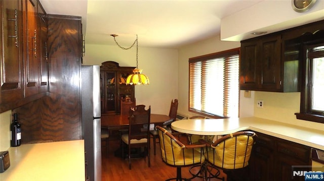 17 Gunther Ave, Lodi, NJ 07644 - kitchen with dark brown cabinetry, wood finished floors, light countertops, and freestanding refrigerator