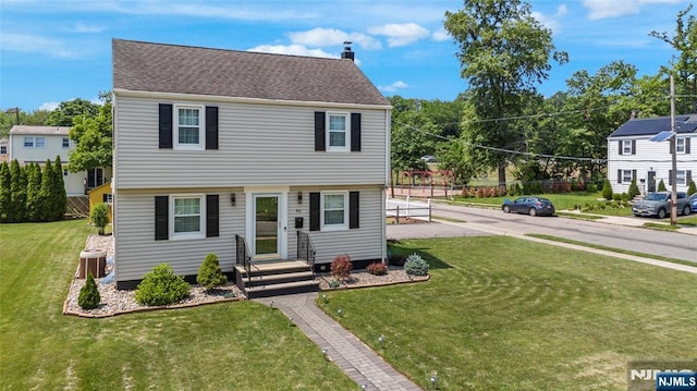 63 Rosedale Ave, Clifton, NJ 07013 - colonial home with a front lawn and a chimney