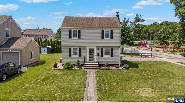 63 Rosedale Ave, Clifton, NJ 07013 - colonial house featuring a shed, a front yard, and a chimney
