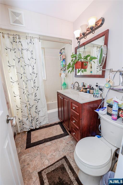 136 Martin Ave, Clifton, NJ 07012 - bathroom featuring shower / bath combination with curtain and vanity