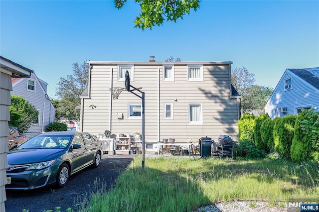 136 Martin Ave, Clifton, NJ 07012 - rear view of property featuring a chimney