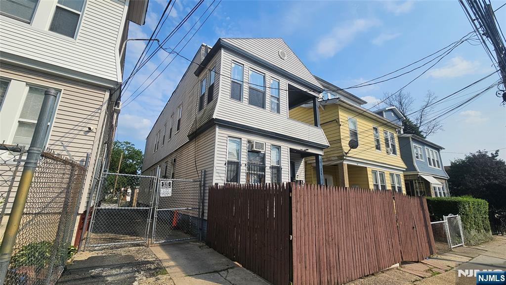 144 Alexander St, Newark, NJ 07106 - view of home's exterior featuring a gate