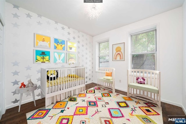 42-44 Prospect St Unit 1C/103, Jersey City, NJ 07307 - bedroom featuring wood finished floors, wallpapered walls, and a crib