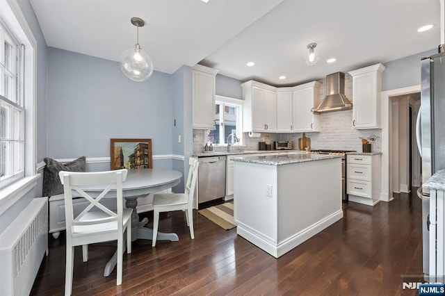 30 Hillcrest Ter, Verona, NJ 07044 - kitchen featuring wall chimney range hood, radiator heating unit, stainless steel appliances, dark wood-style flooring, and white cabinets