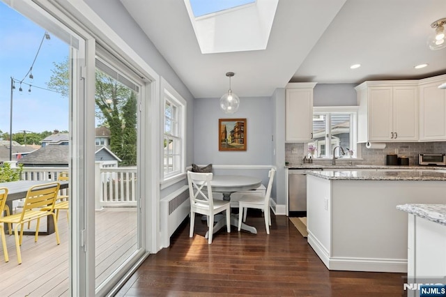 30 Hillcrest Ter, Verona, NJ 07044 - kitchen featuring stainless steel dishwasher, plenty of natural light, a skylight, dark wood-style flooring, and recessed lighting