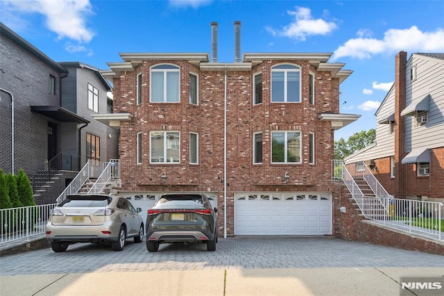 269B 7th St, Palisades Park, NJ 07650 - view of front of home with brick siding, an attached garage, decorative driveway, and stairs