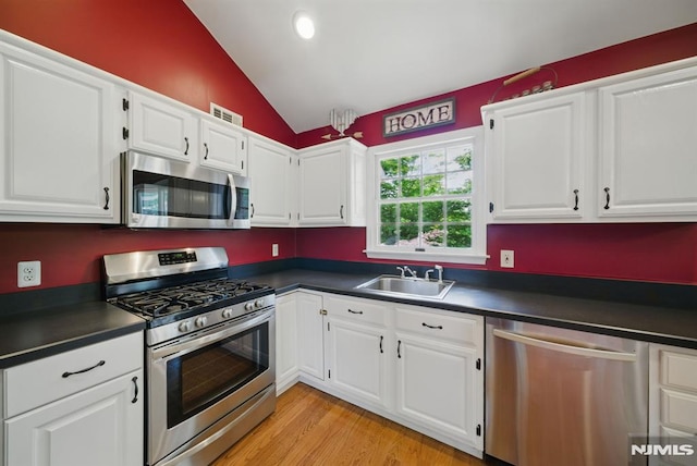 49 Longview Trl, Denville Township, NJ 07834 - kitchen featuring stainless steel appliances, dark countertops, lofted ceiling, white cabinetry, and recessed lighting