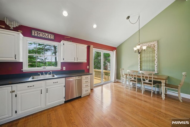 49 Longview Trl, Denville Township, NJ 07834 - kitchen with stainless steel dishwasher, dark countertops, white cabinets, vaulted ceiling, and hanging light fixtures