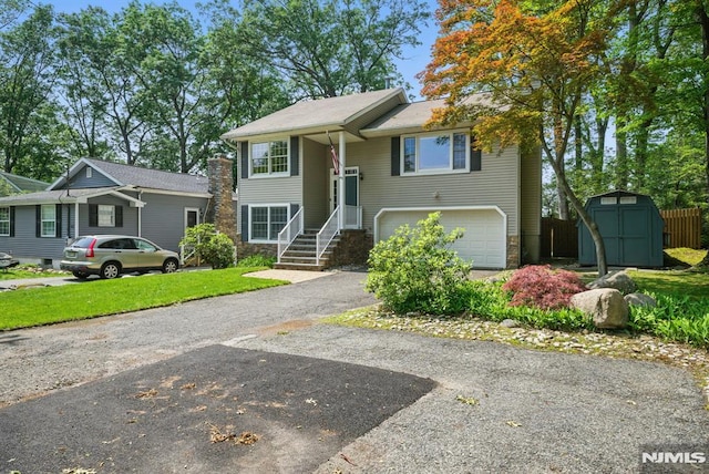 49 Longview Trl, Denville Township, NJ 07834 - bi-level home with a storage unit, an attached garage, driveway, stone siding, and a front yard