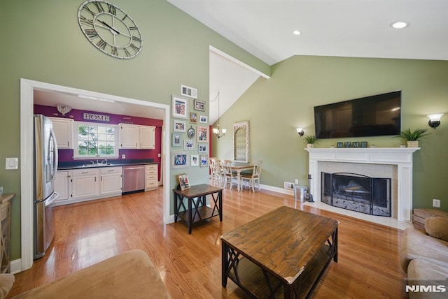 49 Longview Trl, Denville Township, NJ 07834 - living area with high vaulted ceiling, light wood-style floors, a fireplace with flush hearth, and recessed lighting