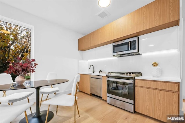 649 38th St Unit 304, Union City, NJ 07087 - kitchen featuring appliances with stainless steel finishes, light wood finished floors, and light countertops