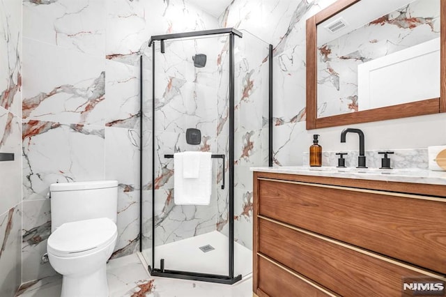649 38th St Unit 304, Union City, NJ 07087 - full bathroom with marble tiled floors, vanity, a marble finish shower, and tile walls