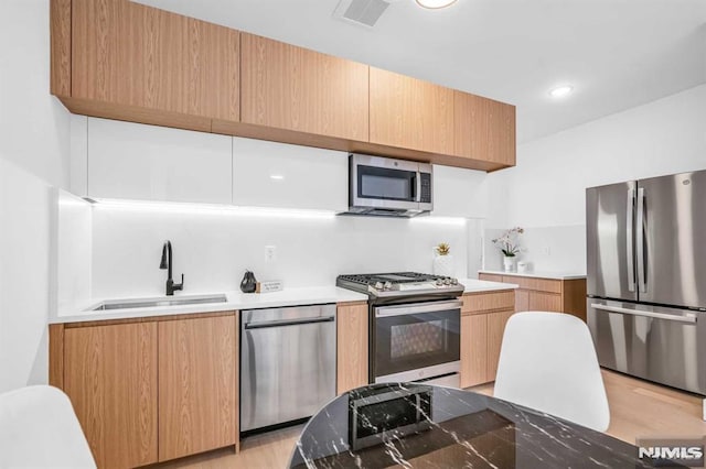 649 38th St Unit 304, Union City, NJ 07087 - kitchen with appliances with stainless steel finishes, light wood finished floors, modern cabinets, and light countertops