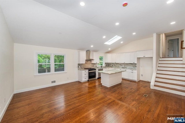 44 Grover Dr, Wayne, NJ 07470 - kitchen with stainless steel appliances, vaulted ceiling, tasteful backsplash, wall chimney range hood, and dark wood-style floors
