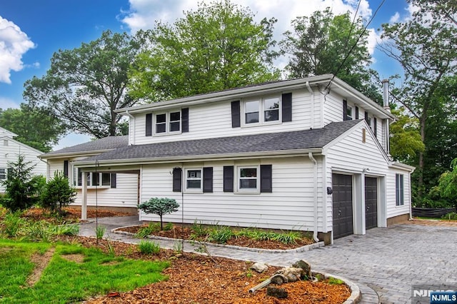 44 Grover Dr, Wayne, NJ 07470 - traditional-style house with decorative driveway, an attached garage, and a shingled roof