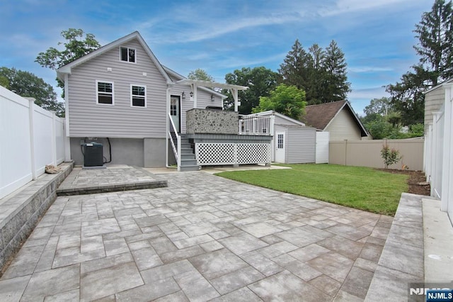 62 Rivervale Rd, Park Ridge, NJ 07656 - back of property with a patio, a fenced backyard, a deck, and a storage shed