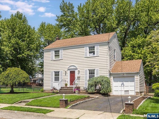 100 Darling Ave, Bloomfield, NJ 07003 - colonial-style house with driveway, a garage, a chimney, and entry steps